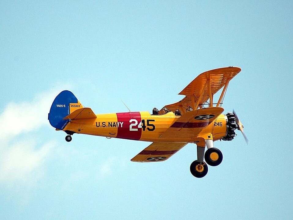 A Flying Aircraft with a Yellow and Red Frame and Blue Tip
